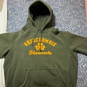 Vintage Abercrombie & Fitch Olive Green Shamrocks Hoodie with Yellow Accents.